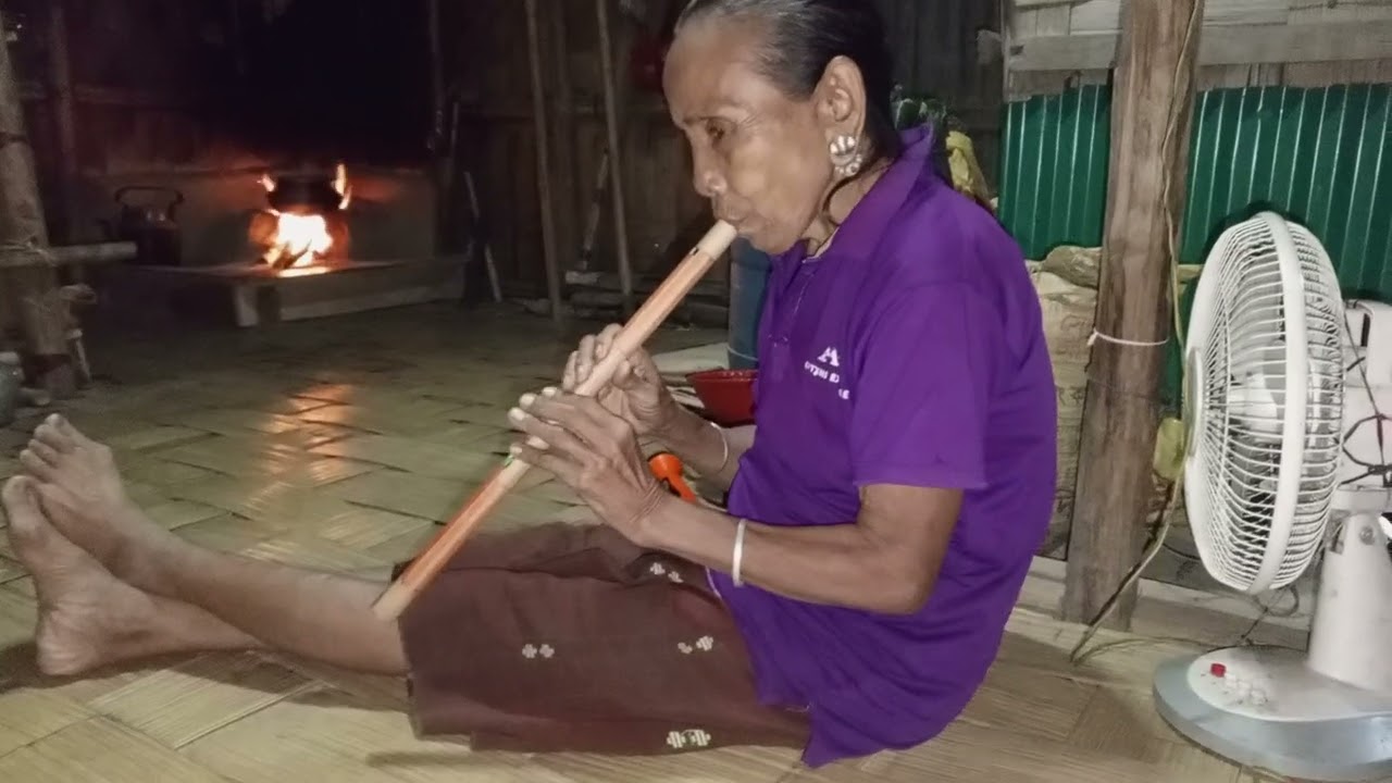 mro woman playing cultural flute