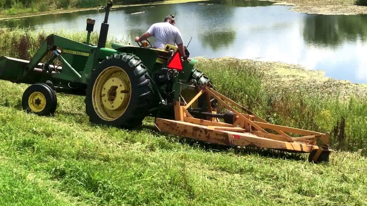 John Deere 3020 with Woods Rotary Cutter cutting willows around pond