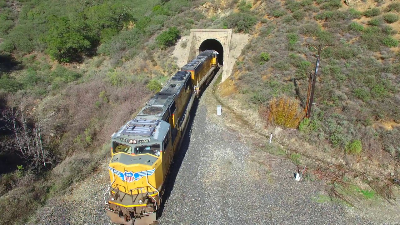 Drone Chasing 2 Union Pacific Freight Engines Passing Through Cuesta Grade Tunnels [4k]