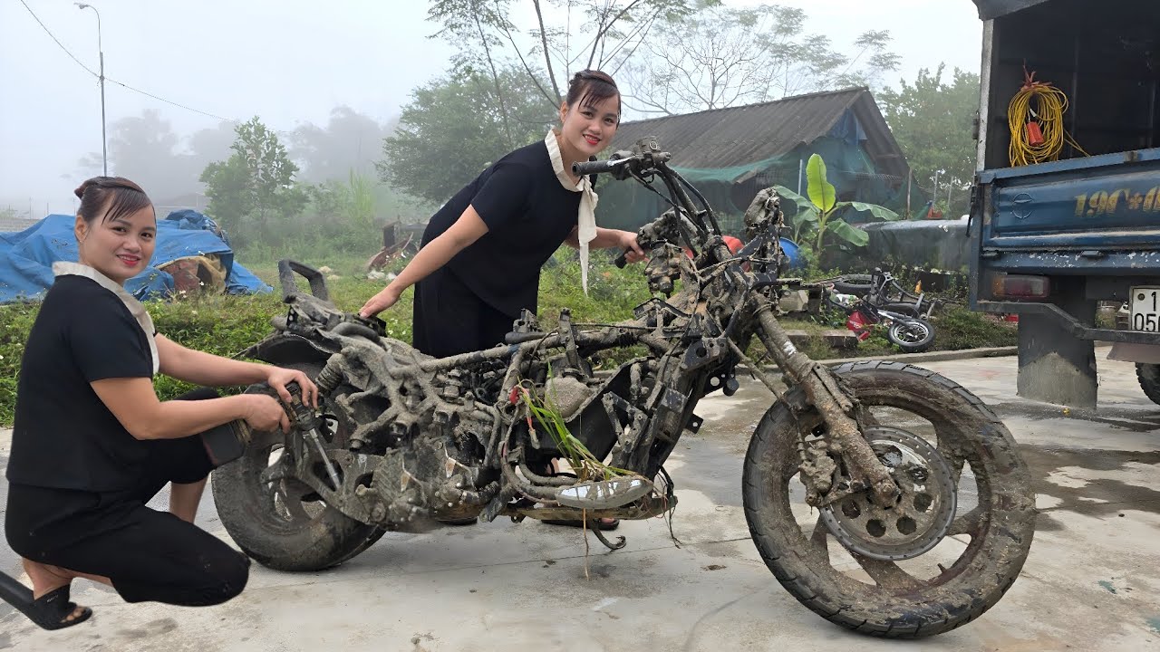 Girl repairs and restores the engine of an old motorbike.