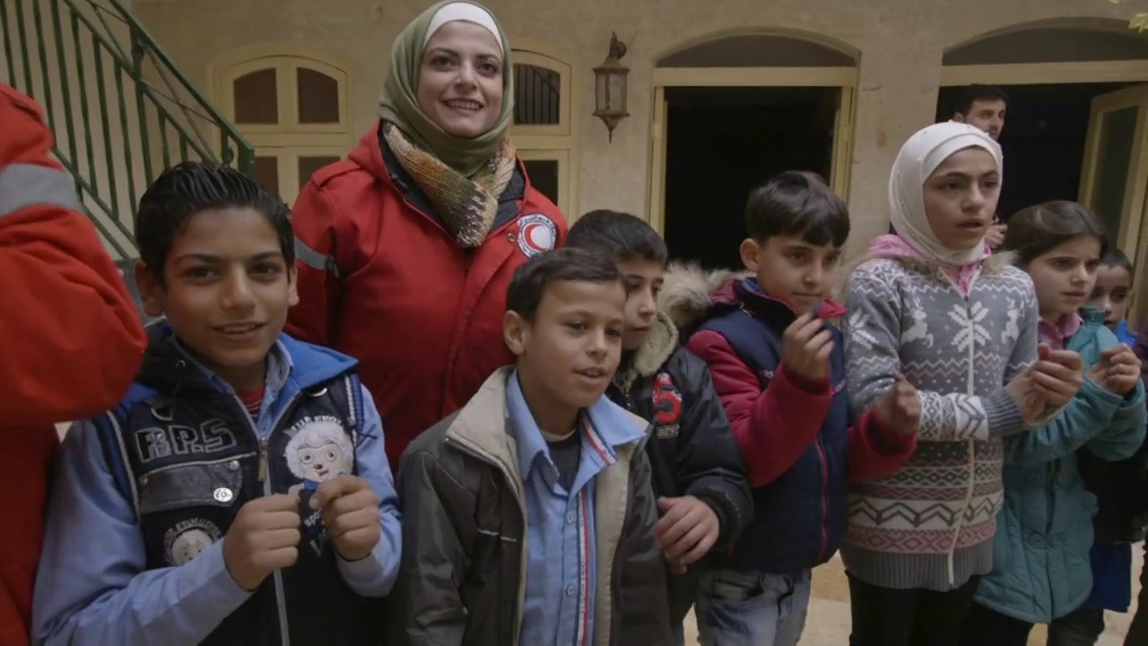 Children play with Syrian Arab Red Crescent volunteers at a community centre in Eastern Aleppo.