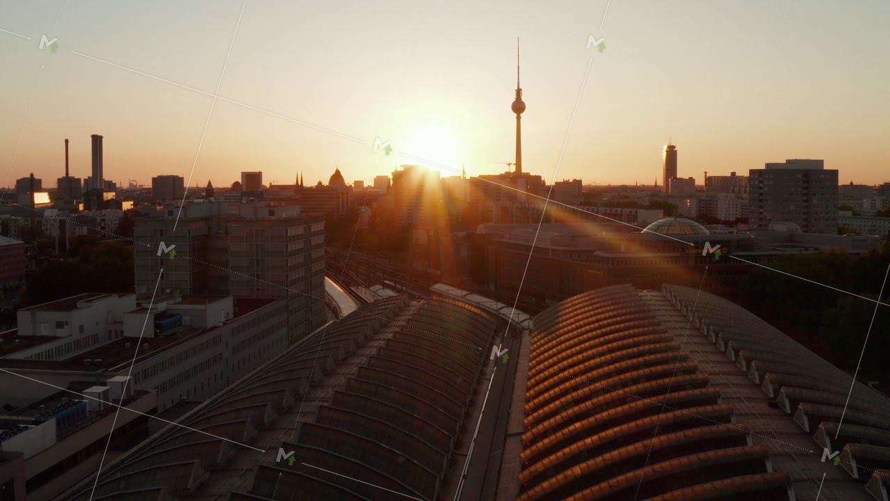 AERIAL: Flight over Berlin, Germany Ostbahnhof Central Train Station at beautiful Sunset, Sunlight