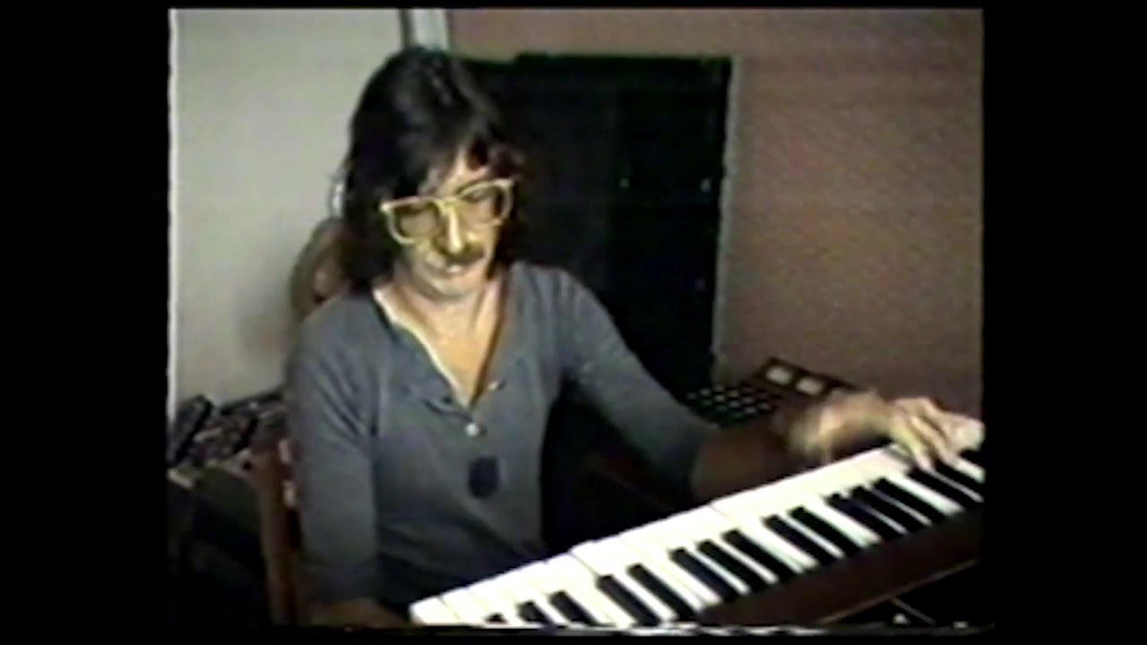 strange man with bi-colored mustache playing vulfpeck in the eighties