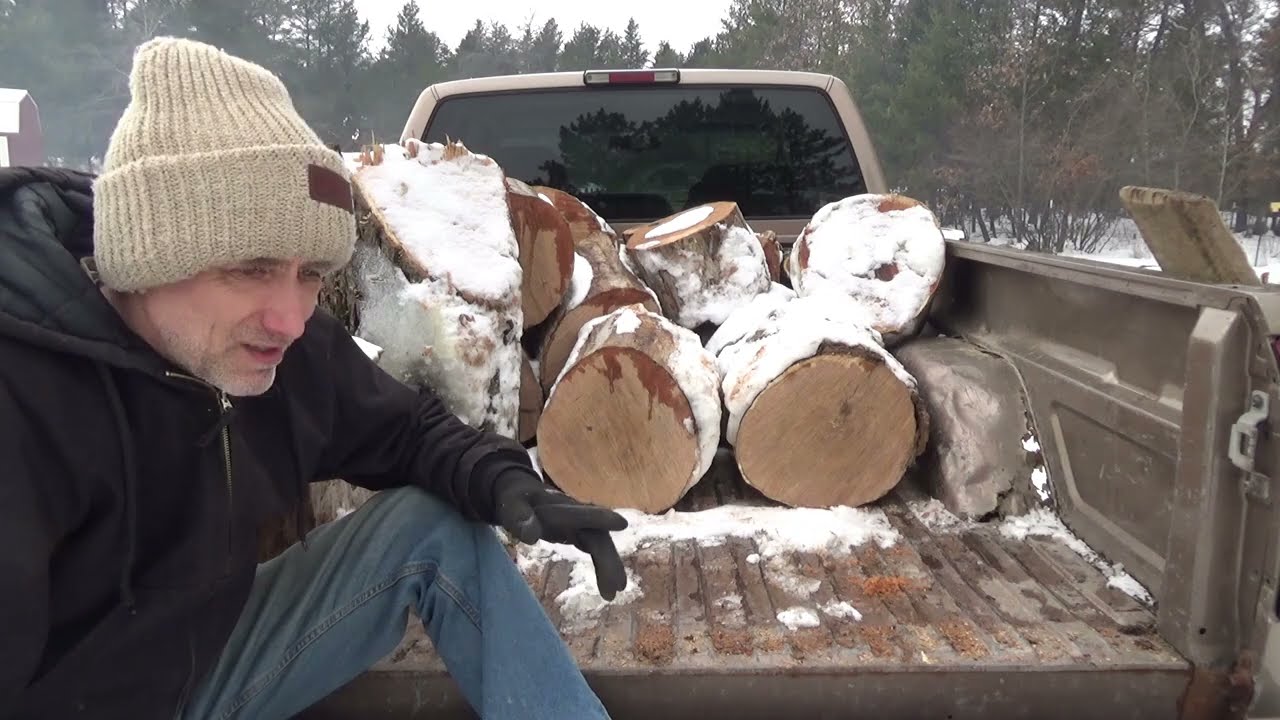 Processing Firewood In Snowy Cold Winter Is Hard Work