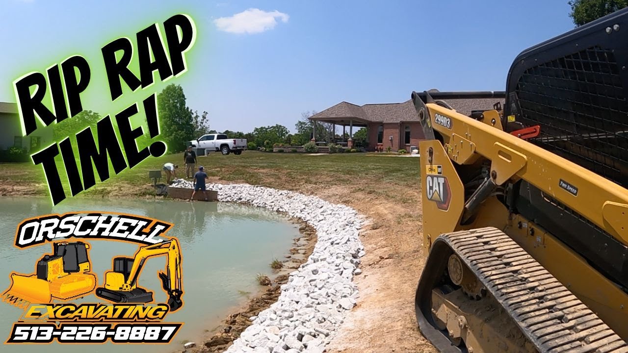 Idaho goes swimming while installing the rip rap around the pond.
