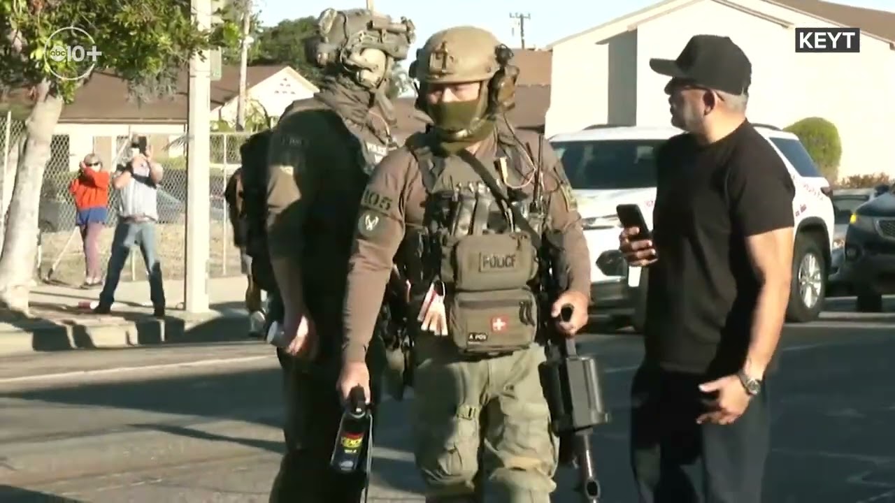 Protesters gather on an Oxnard street in response to ICE agents' presence