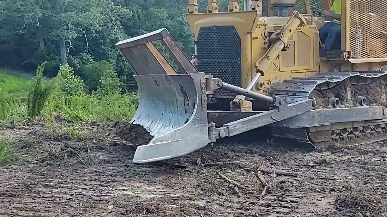 Clearing land with a d7 dozer and a clearing blade