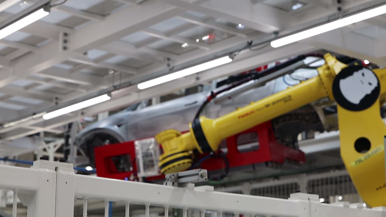 Gigafactory 4 Berlin-Brandenburg Germany robot arm for the transport of whole Tesla car bodies