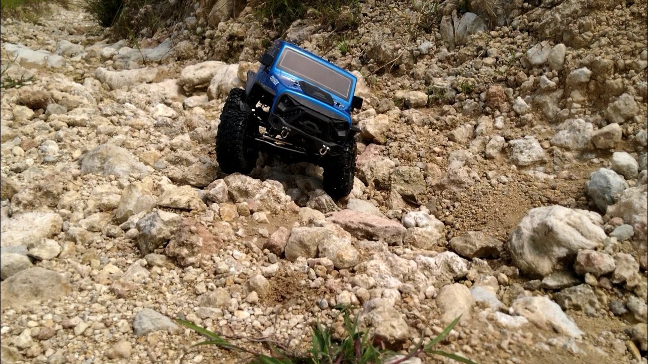 RC RGT EX86100 V2 RC Car Off Road Adventure Across Rocky Roads and Puddles