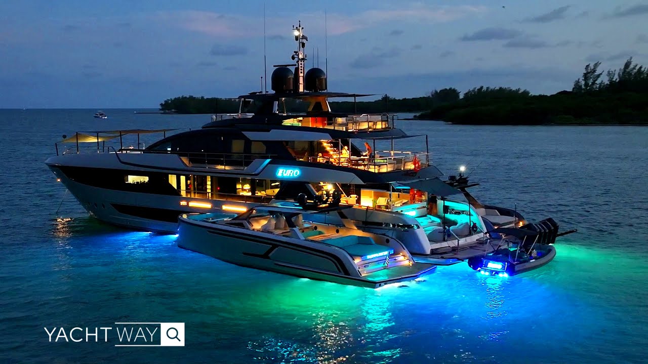 A magnificent Riva yacht takes center stage, escorted by a pair of sleek Vanquish yachts.
