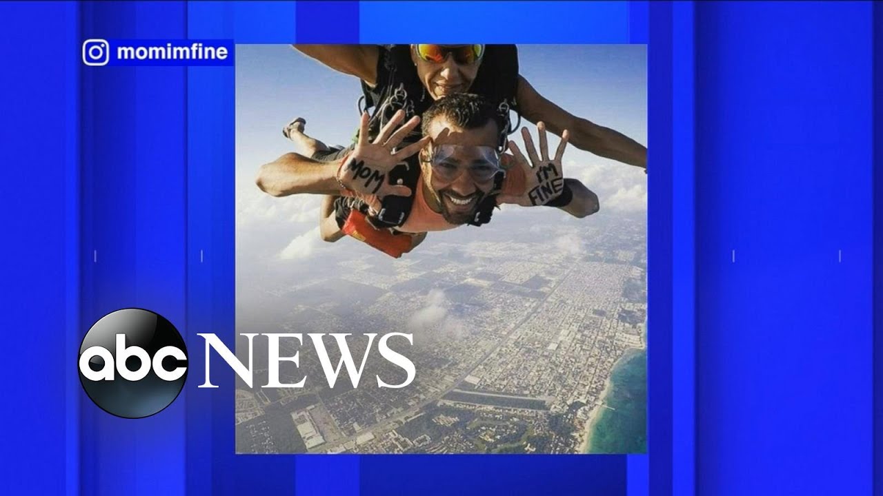 World Traveler Assures Mother He's Safe With 'Mom, I'm Fine' Signs