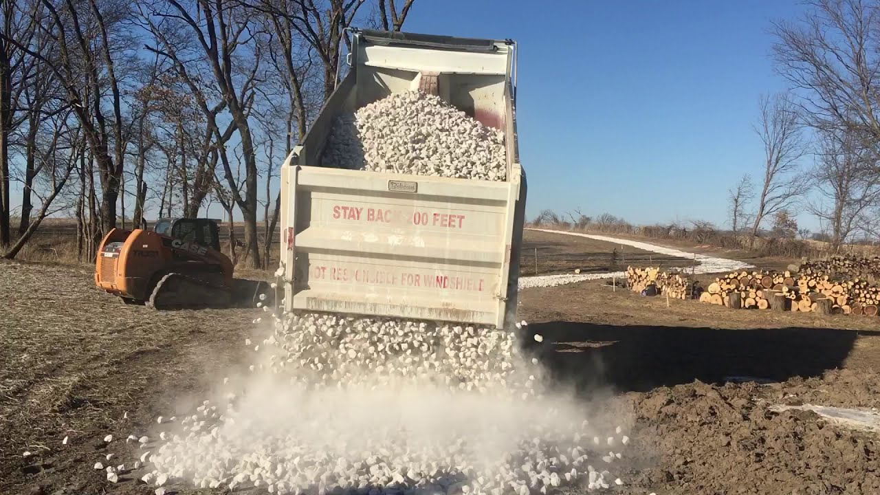 Spreading 3 inch Rock making a Driveway through a Corn Field