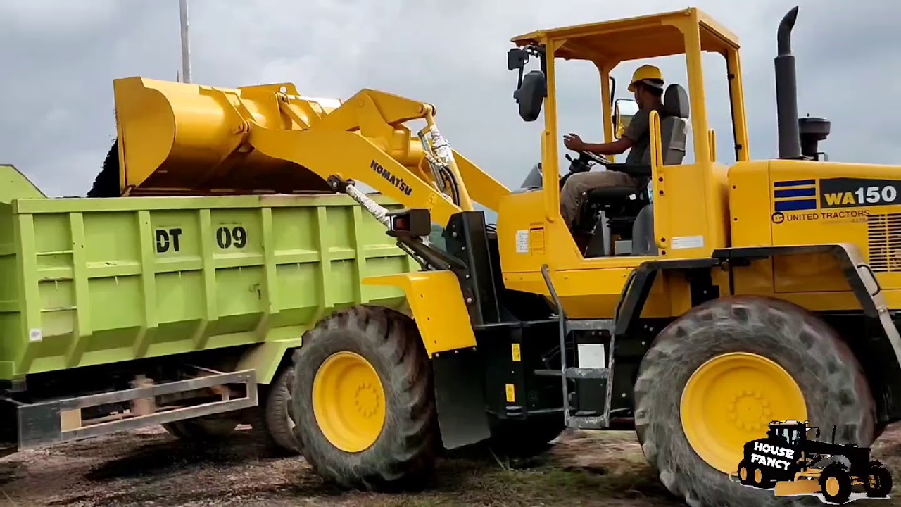 Wheel Loader KOMATSU WA 150 Loading Palm Shells Into Dump Truck