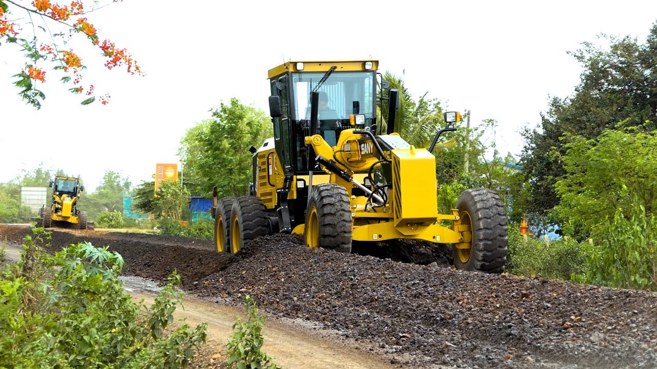 Huge SANY grader, Sakai road roller, and water-spraying Hyundai truck at a road construction site