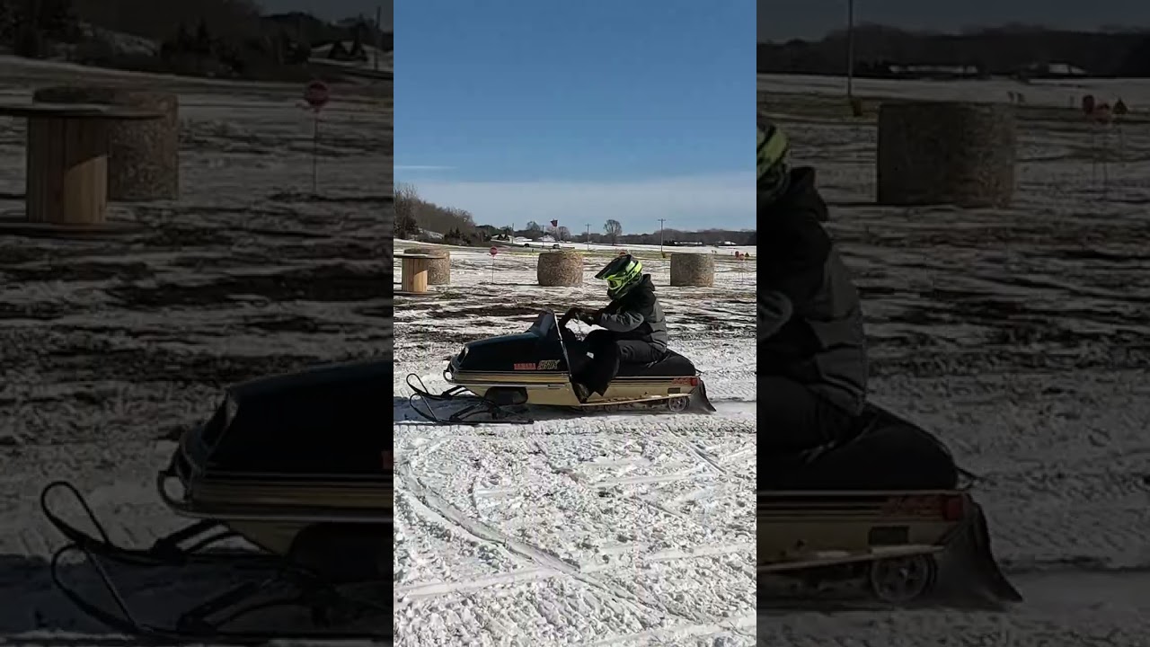 Vintage Yamaha SRX Snowmobile black and gold gets air
