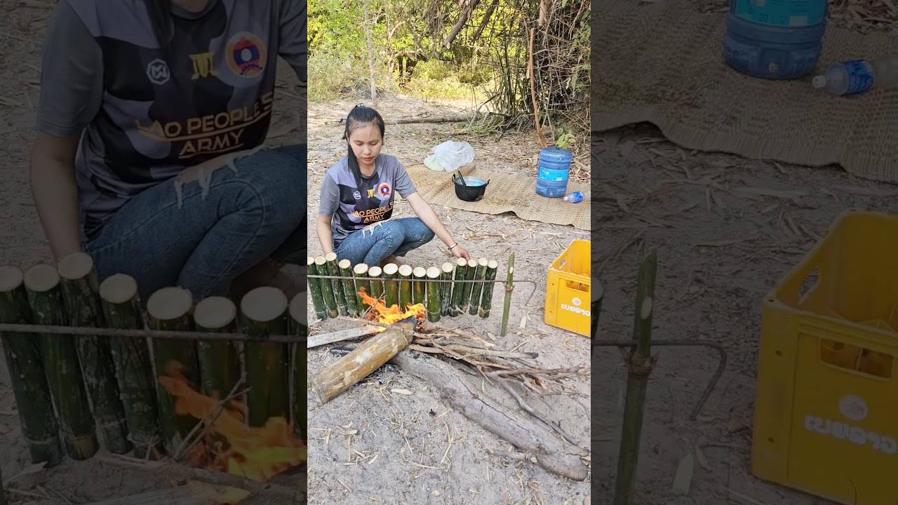Lao girl is burning sticky rice in bamboo tubes called Khao Lam. 