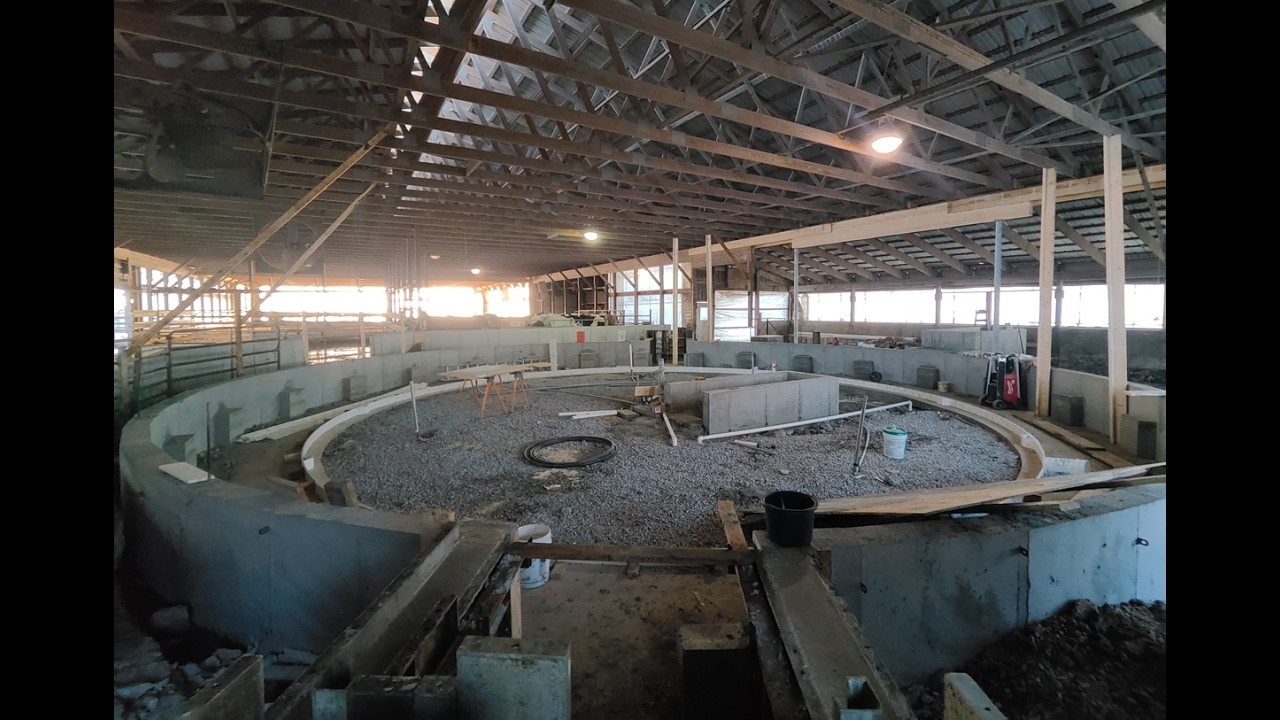 Internal Rotary Parlor Walls Are Poured - Using A Crane To Set A Beam In Place