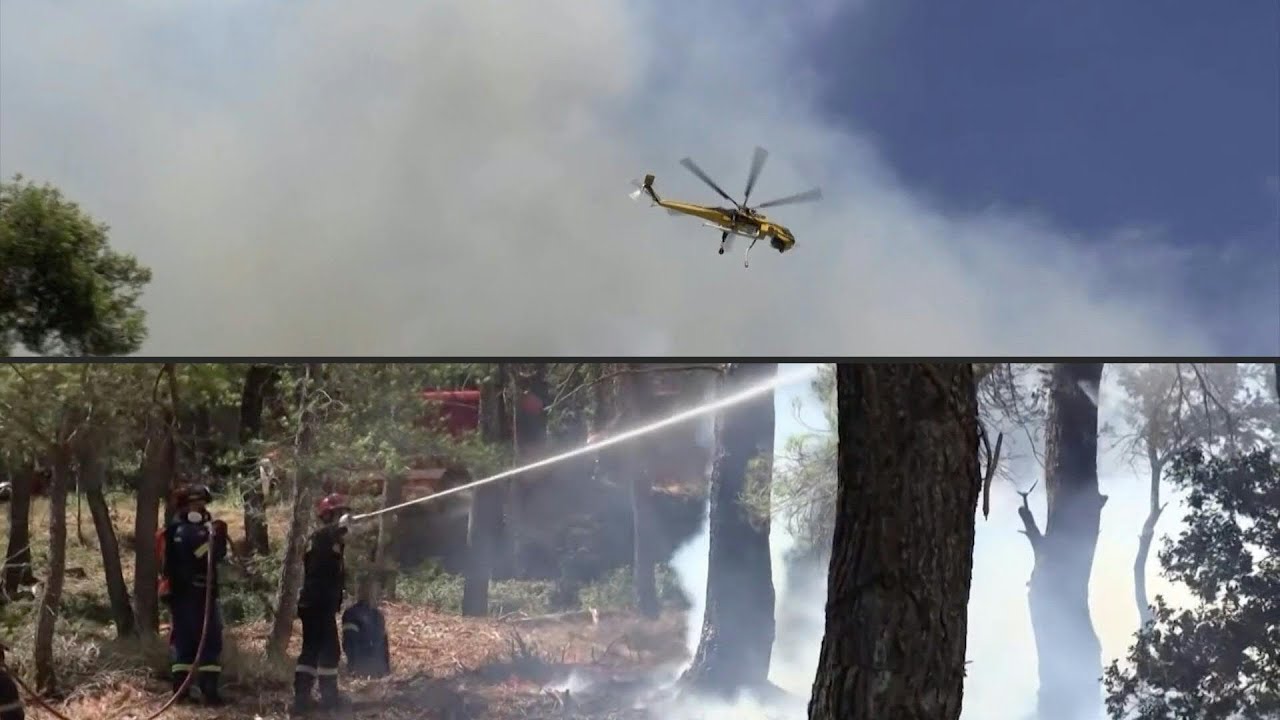 Firefighters battle blazes in the hills of Greece's Porto Germeno | AFP
