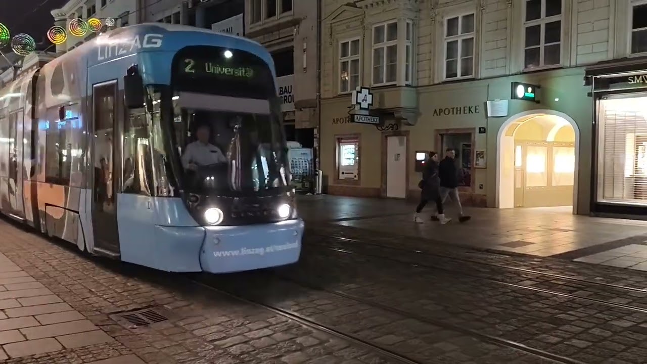 Tram in Linz harbor, advertising under the old Christmas lights