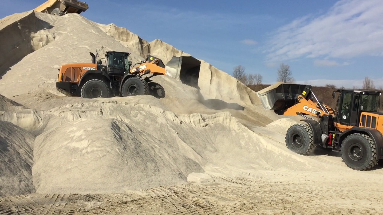 New CASE 1021G and 921G wheel loaders, playing in a sand pit