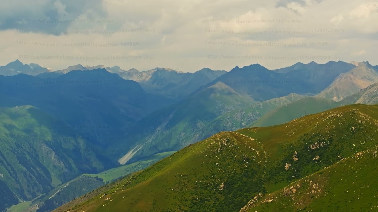 Majestic mountains under cloudy sky in serene landscape, drone view