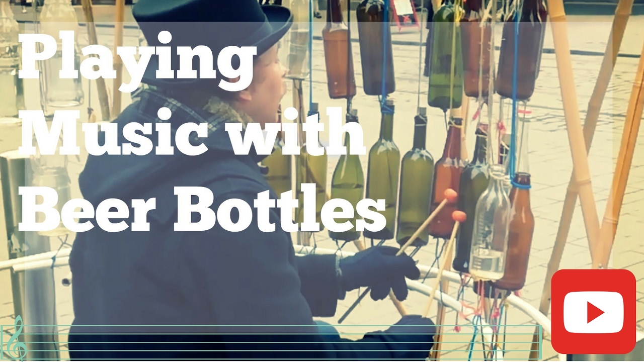 Man who plays music with half filled beer bottles.