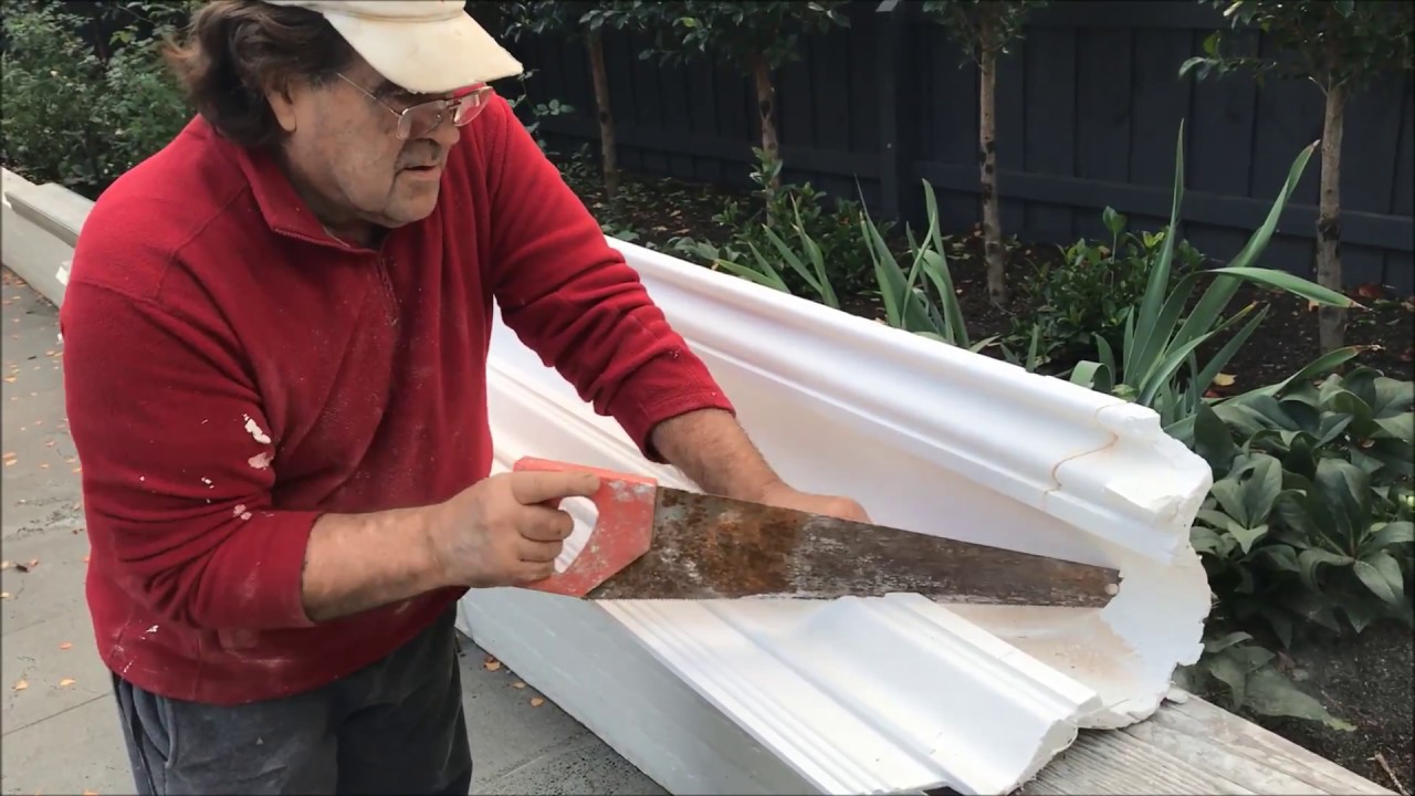 Installing large Hopkin's Large Victorian cornice around cupboards