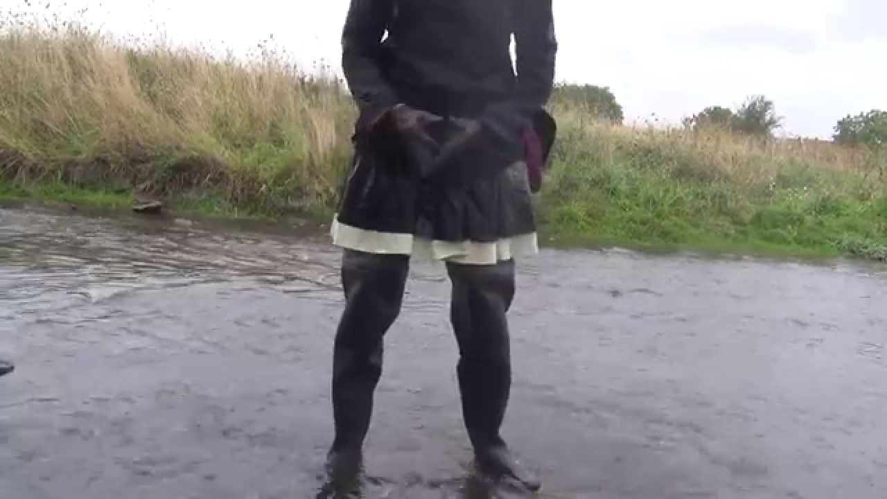 walking through the river in black chestwaders