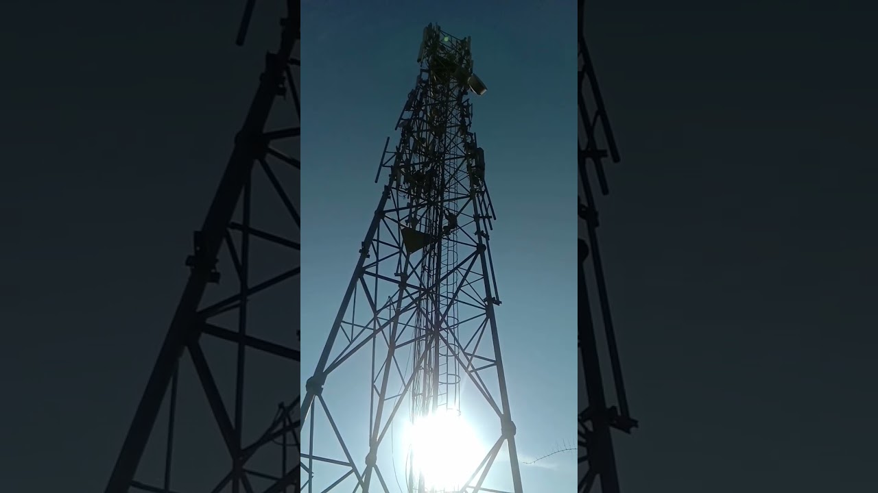 man climbs cell tower