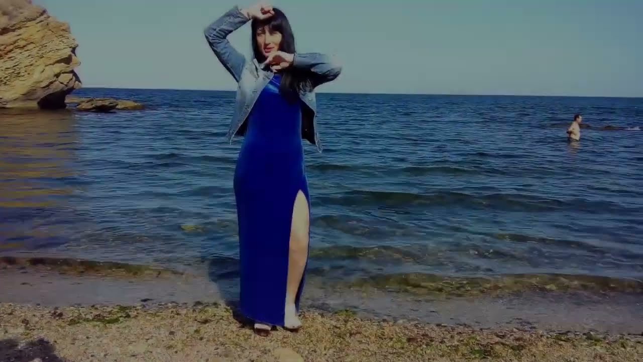 girl in a wet dress and a wet denim jacket at the sea