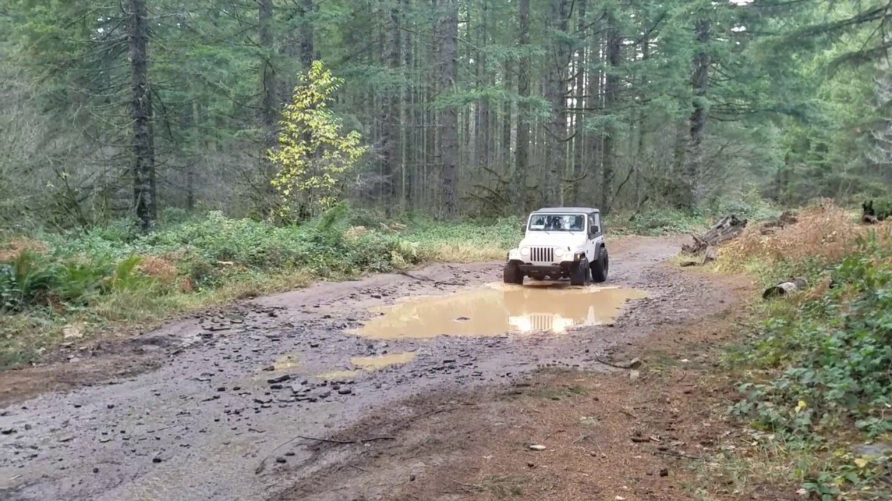 Jeep TJ SE on 35" Baja claws in a deep hole at crooked finger
