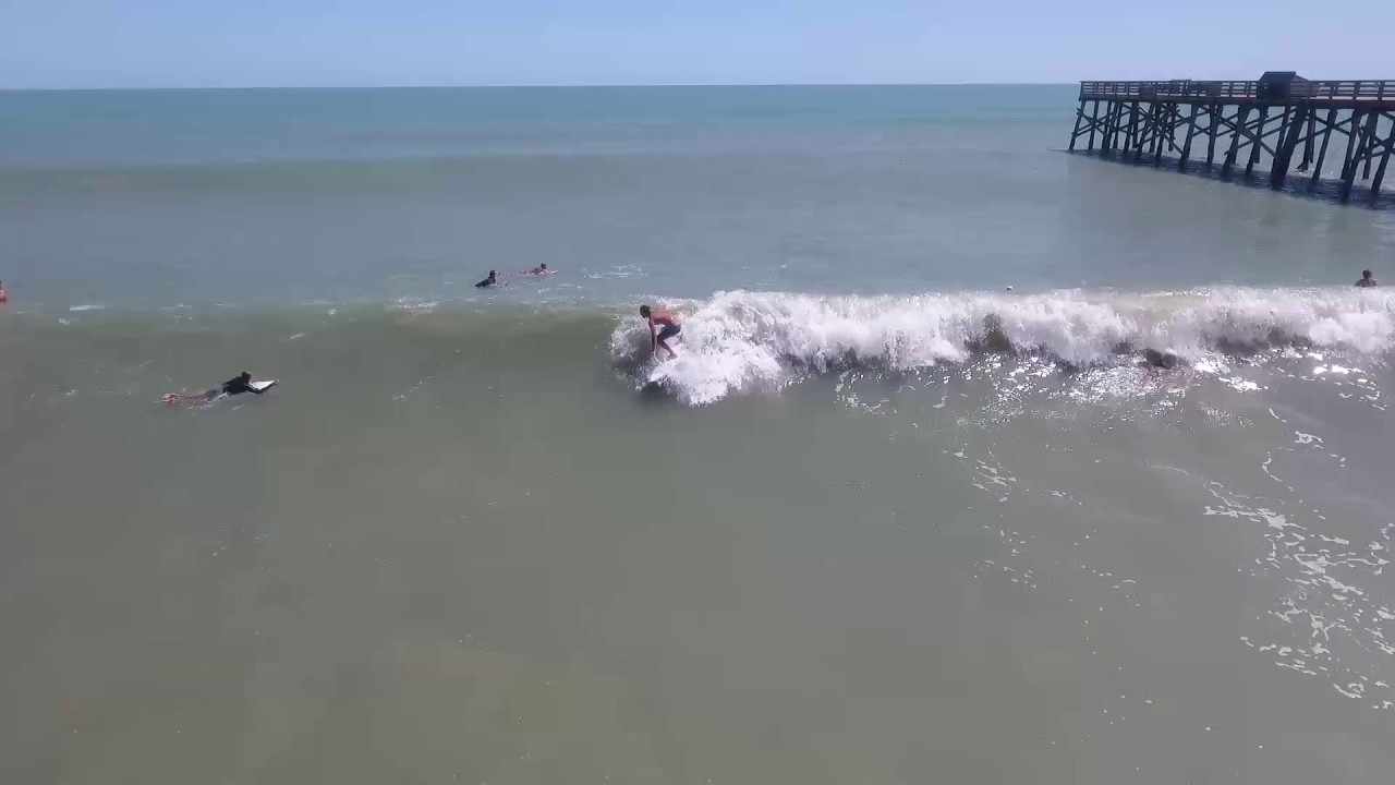 Surfers at Flagler Beach pier