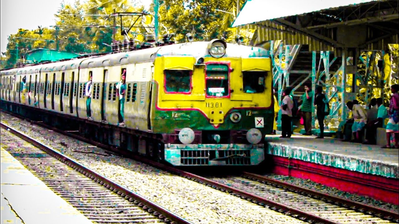 The crowded old Green EMU local train entered the station at Noon