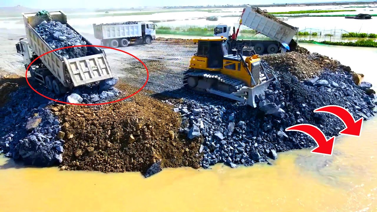 Nice stone pushing bulldozer,SHACMAN truck dumping enormous stone, building road on water