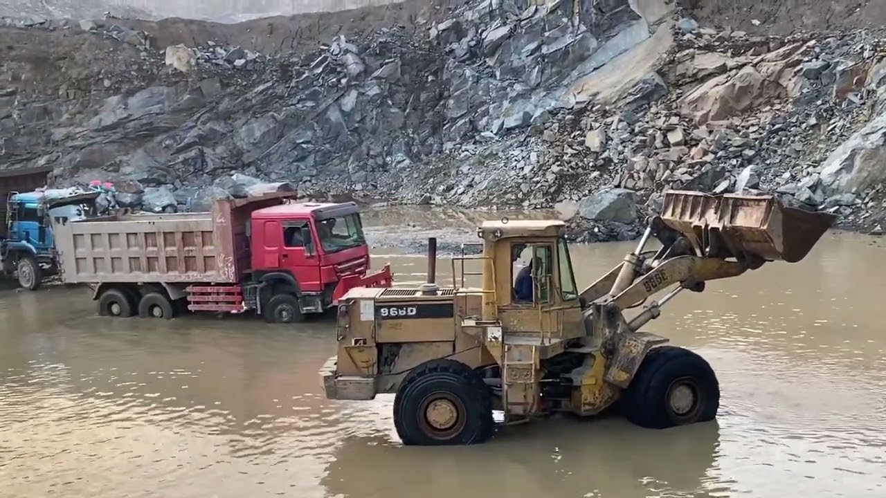 Caterpillar loader loading the truck and black stone mountain view 