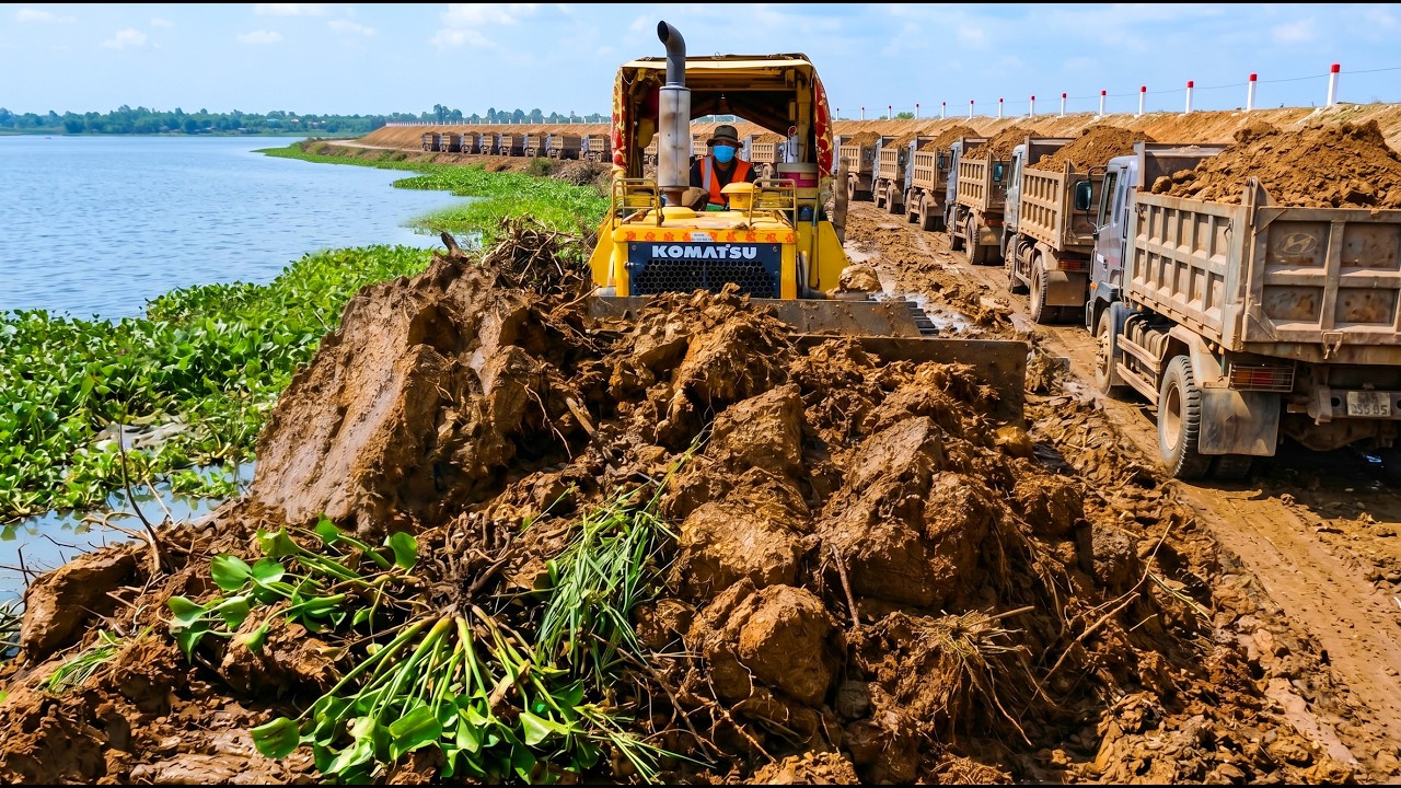 Skilled Bulldozer Optimizing Massive Road Base While Dump Trucks Supply Endless Soil