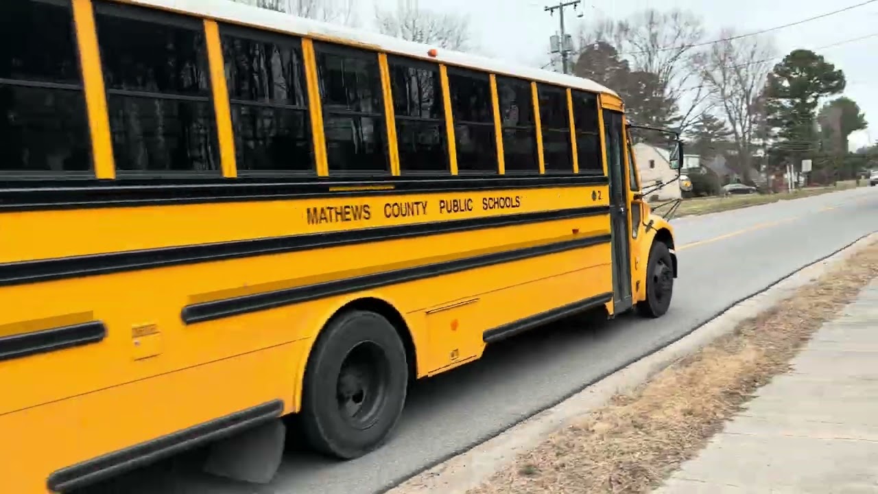 Bus 2 passing by and Bus D 5 slowing down and idling 