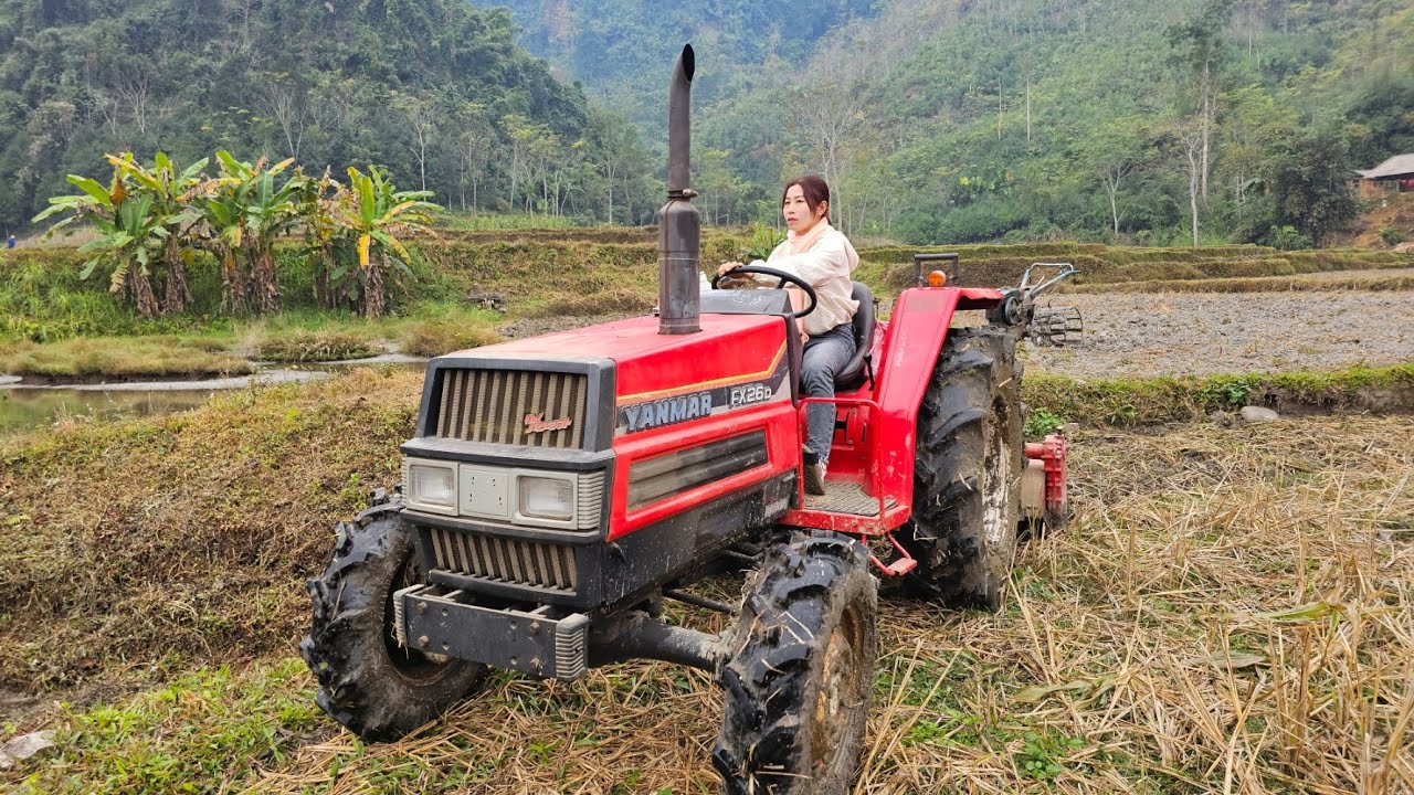 female agricultural vehicle driver - moving machine to another area to dry soil for farming