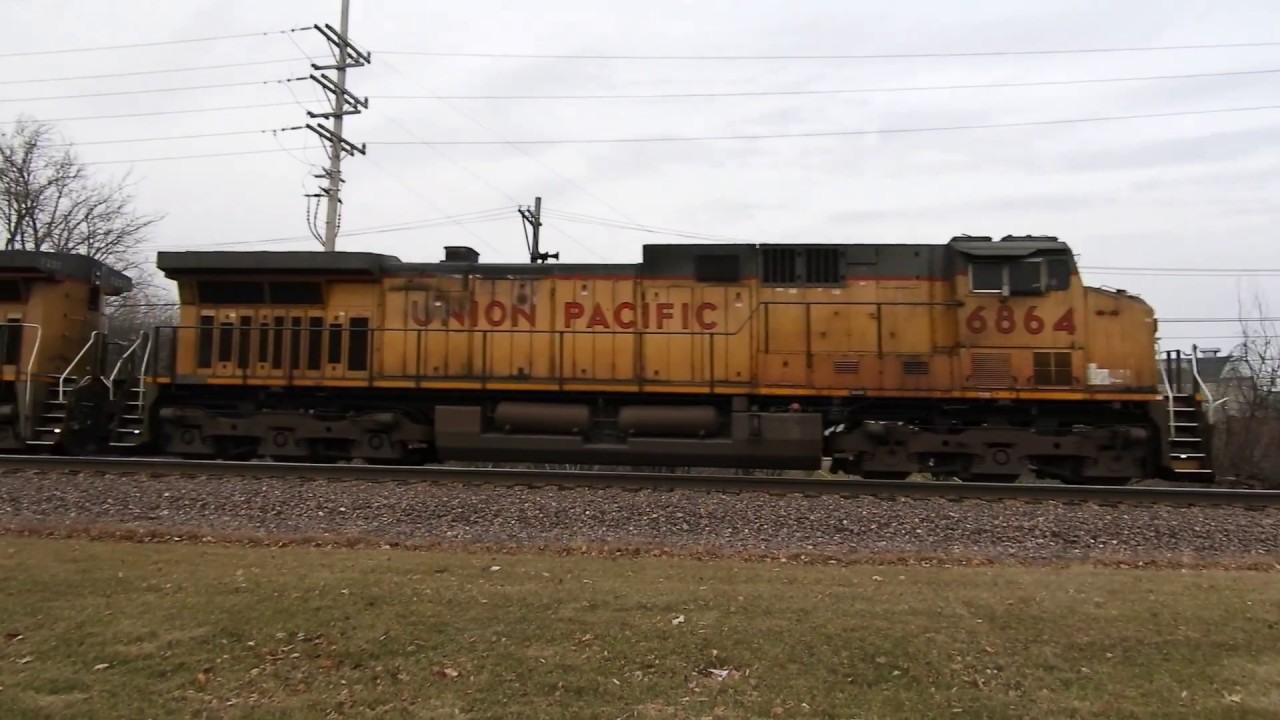 UP 6864 a C44AC leads a loaded coal train east through Geneva IL