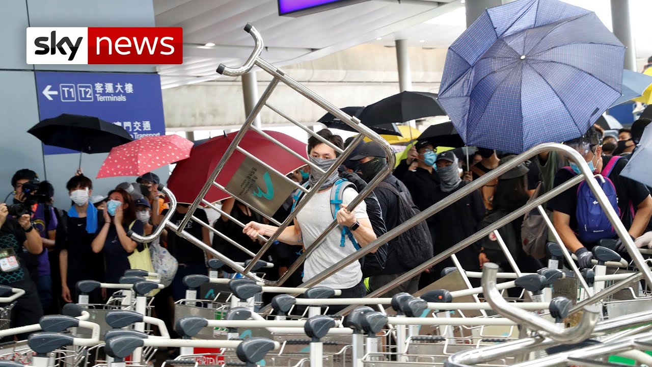 Protesters set fire to barricades to block access to Hong Kong airport