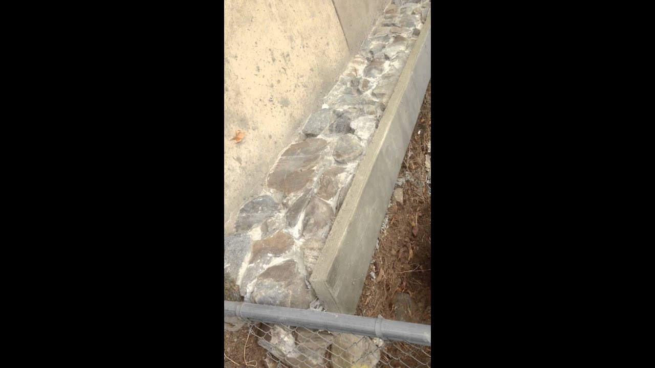 finished stone wall with concrete cap