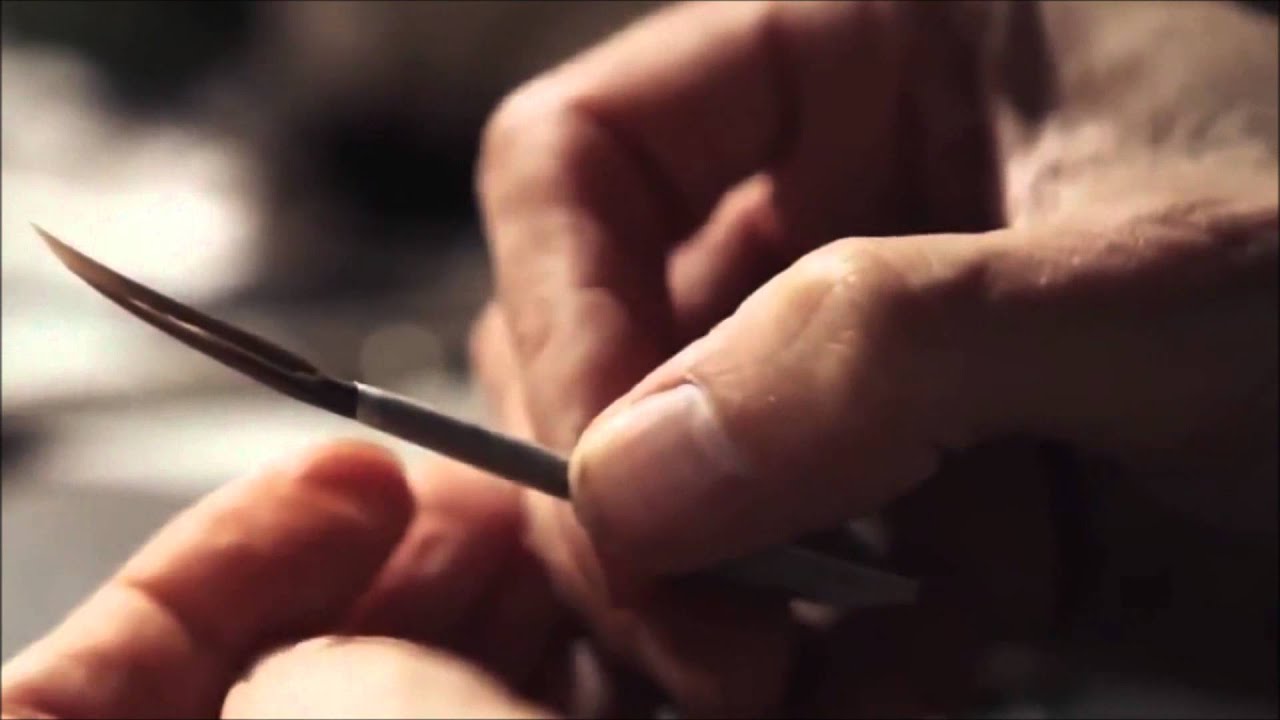 Making a paintbrush from a feather.