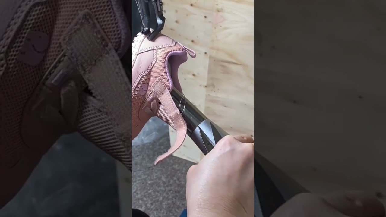 Precision sewing machine stitching the soles of pink shoes