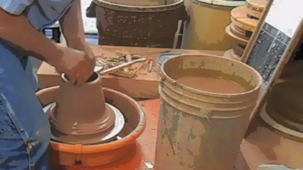 Centering a ball of clay and throwing a pot.