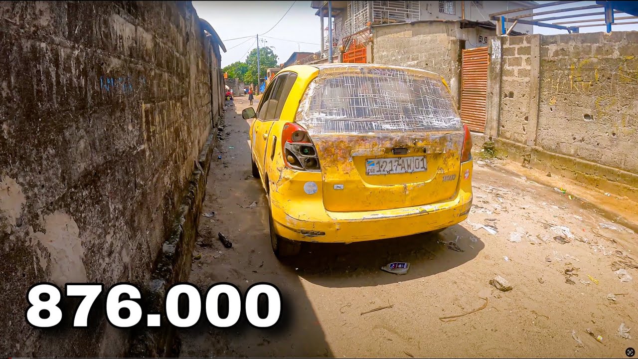 Driving trough an African village with a Toyota Corolla Spacio