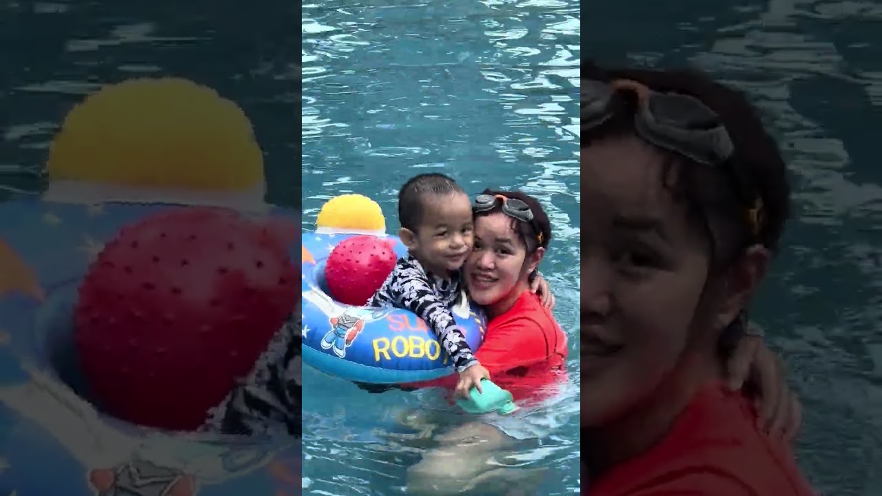 Baby swimming with Mommy and Daddy