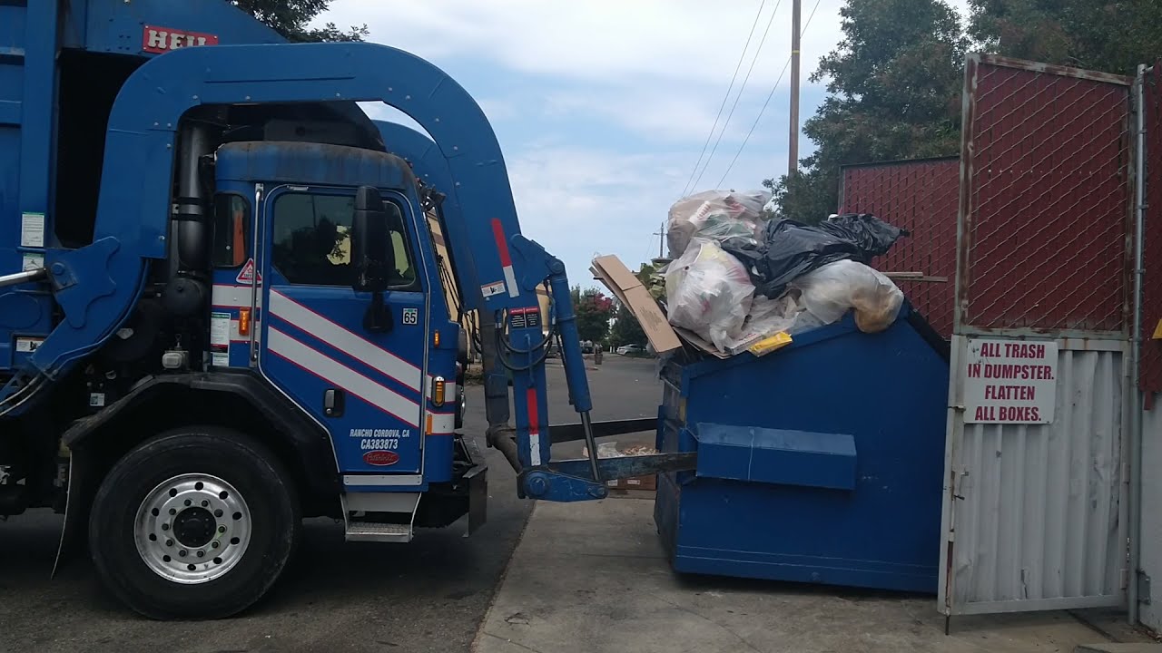 REPUBLIC FRONT LOADER GARBAGE TRUCK PICKING UP DUMPSTERS TRUCK NUMBER IS 1278