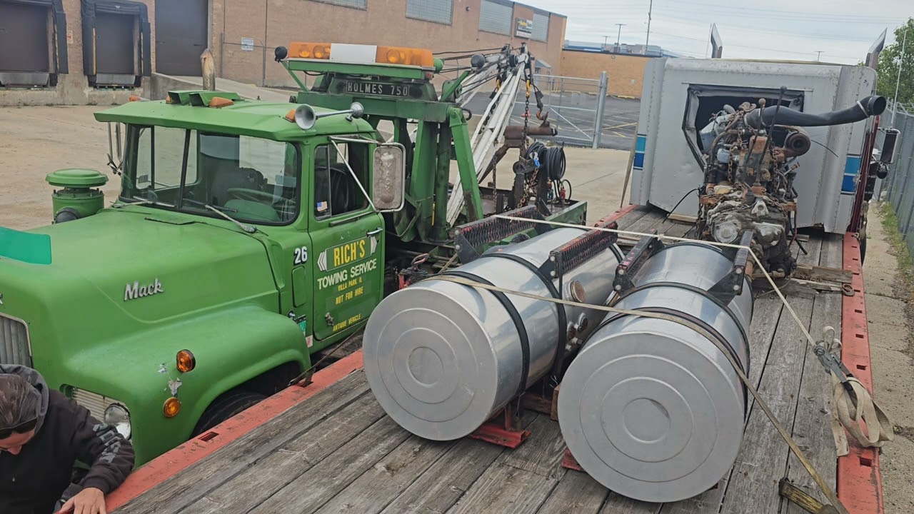 Mack R model with 750 Holmes wrecker unloading Mack diesel.