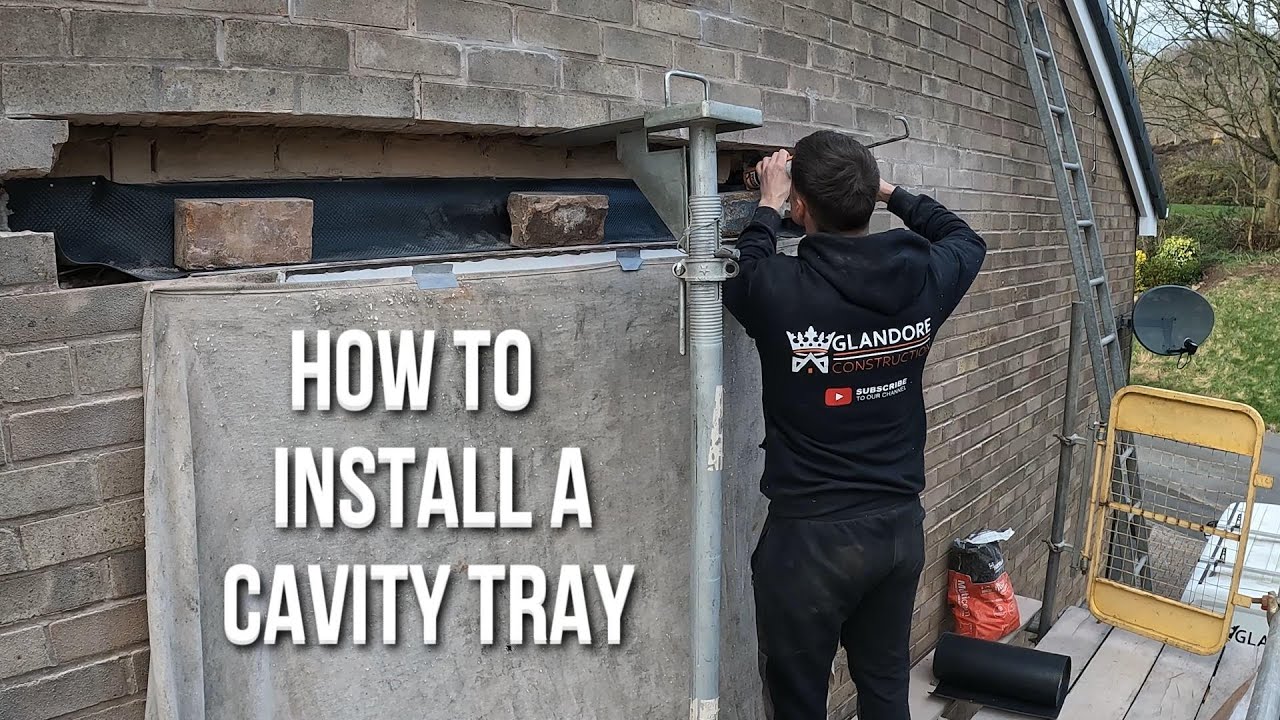Bricklayer installing a cavity tray