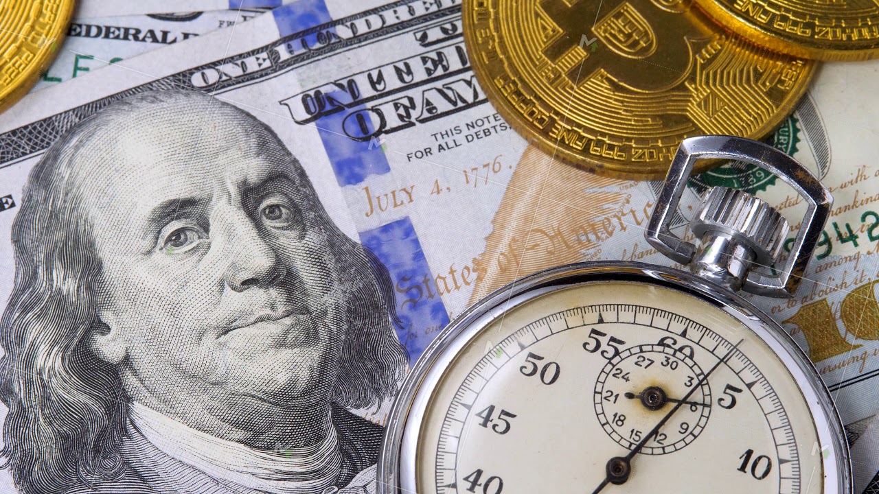 Silver clocks run time on one hundred american dollars bills with virtual BTC Bitcoins